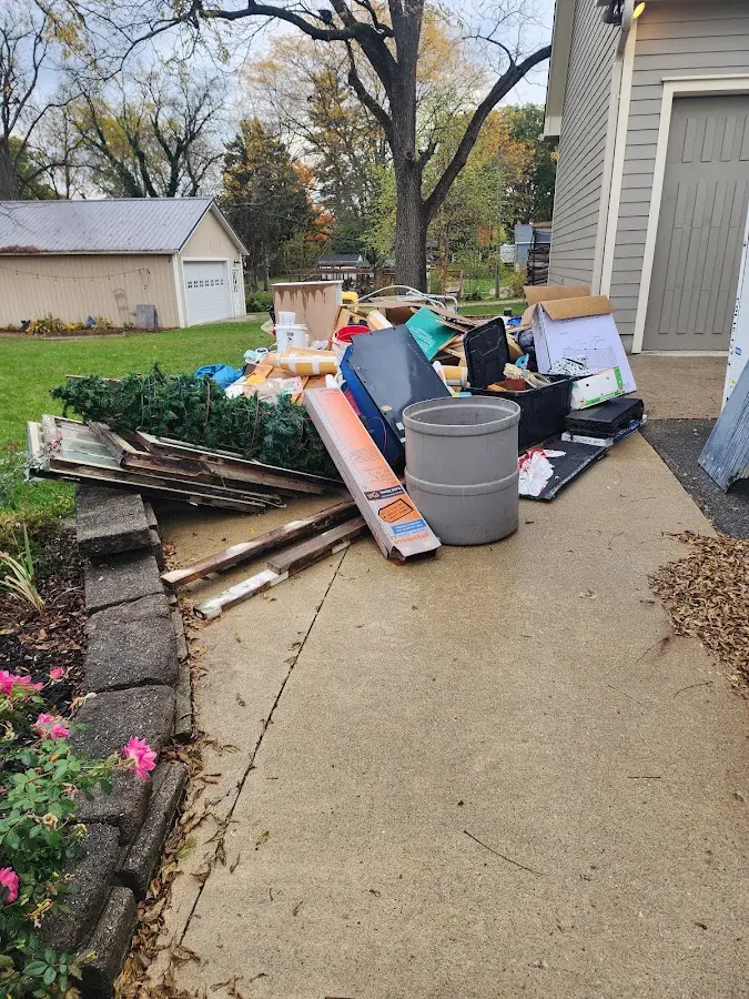 Dumpster being loaded with debris for Commercial Dumpster Rental in Moody